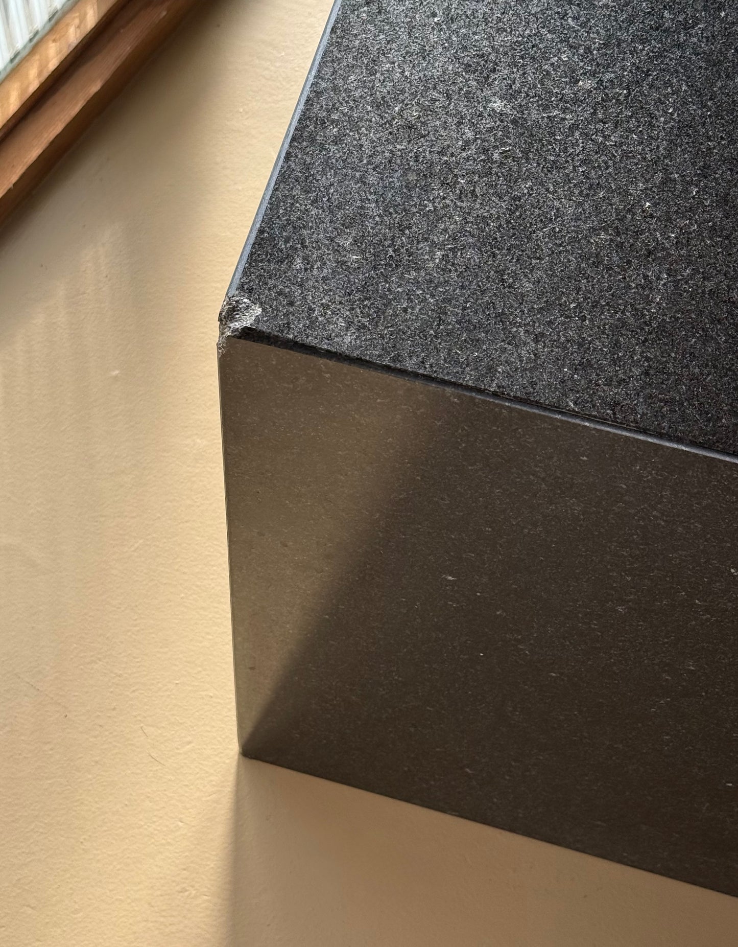 Pair of postmodern black granite triangular end tables, late 20th century