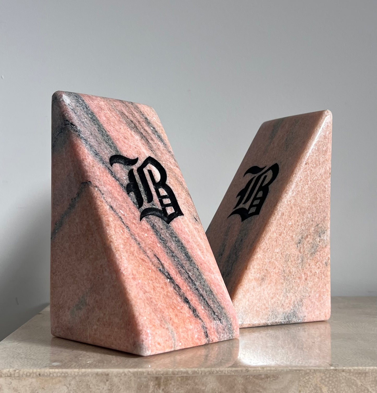 Postmodern pink marble “B” bookends, 20th century