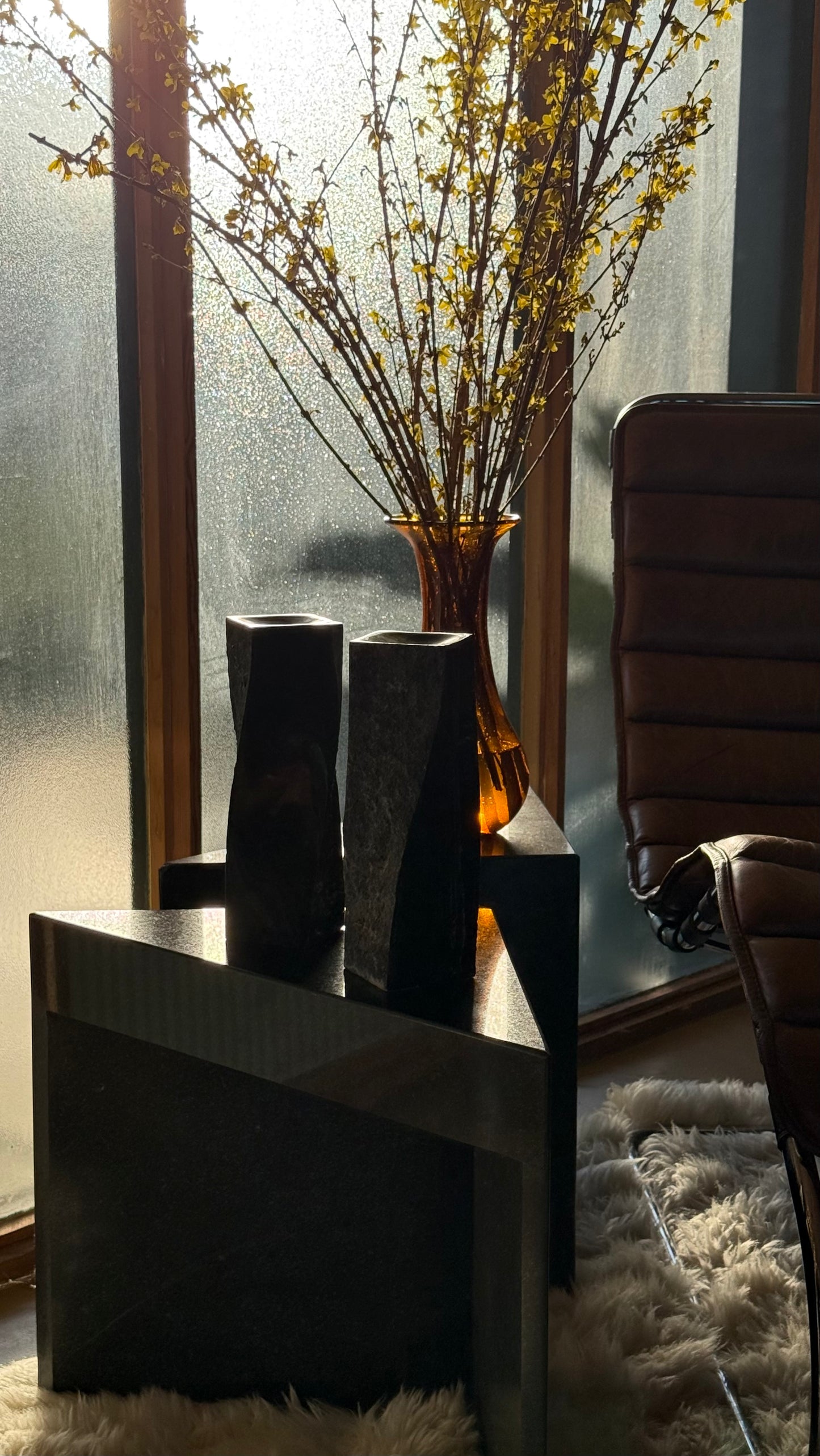 Pair of black stone candlesticks, late 20th century
