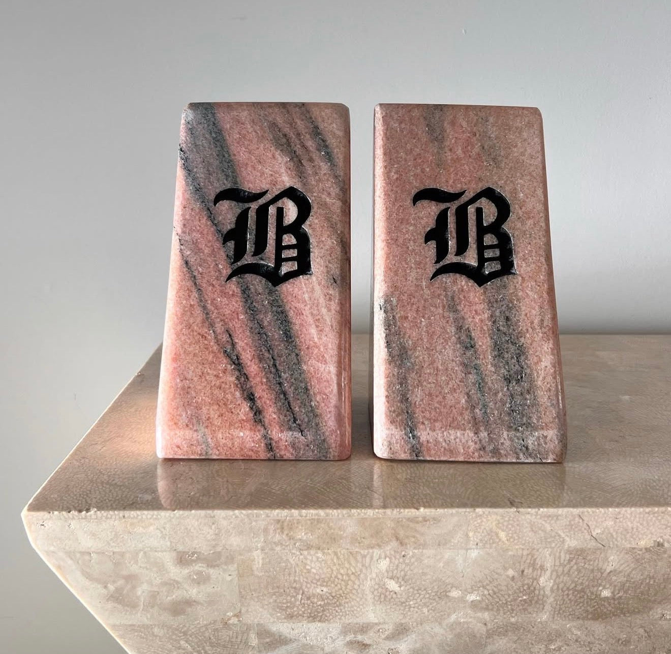 Postmodern pink marble “B” bookends, 20th century