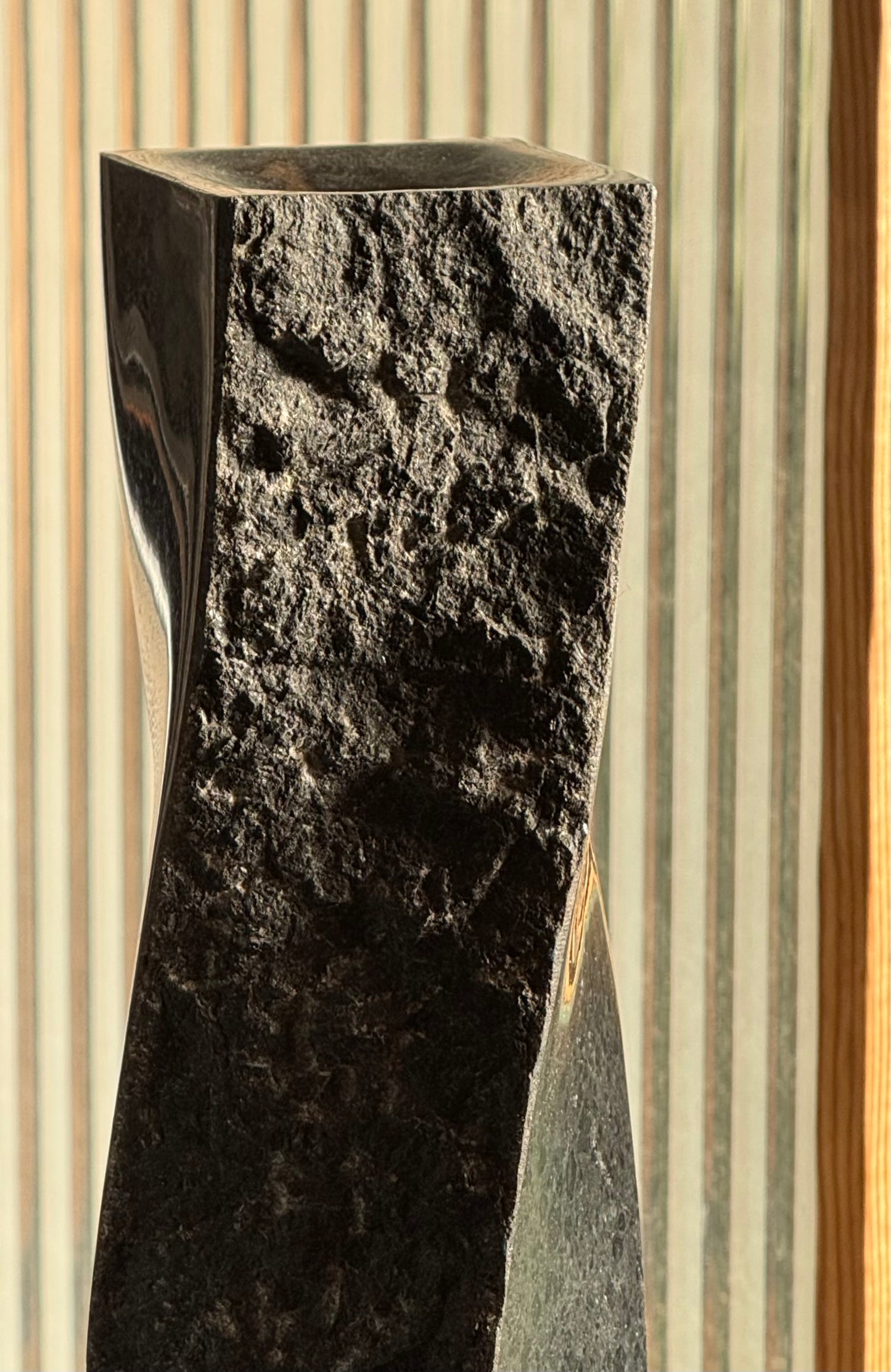 Pair of black stone candlesticks, late 20th century