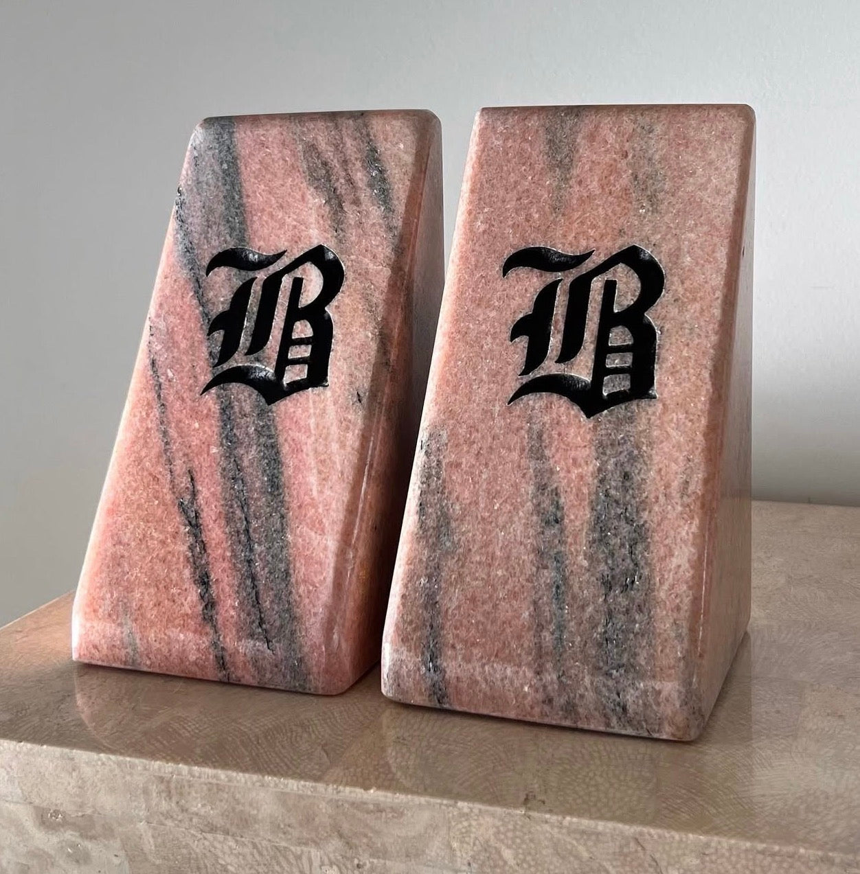 Postmodern pink marble “B” bookends, 20th century