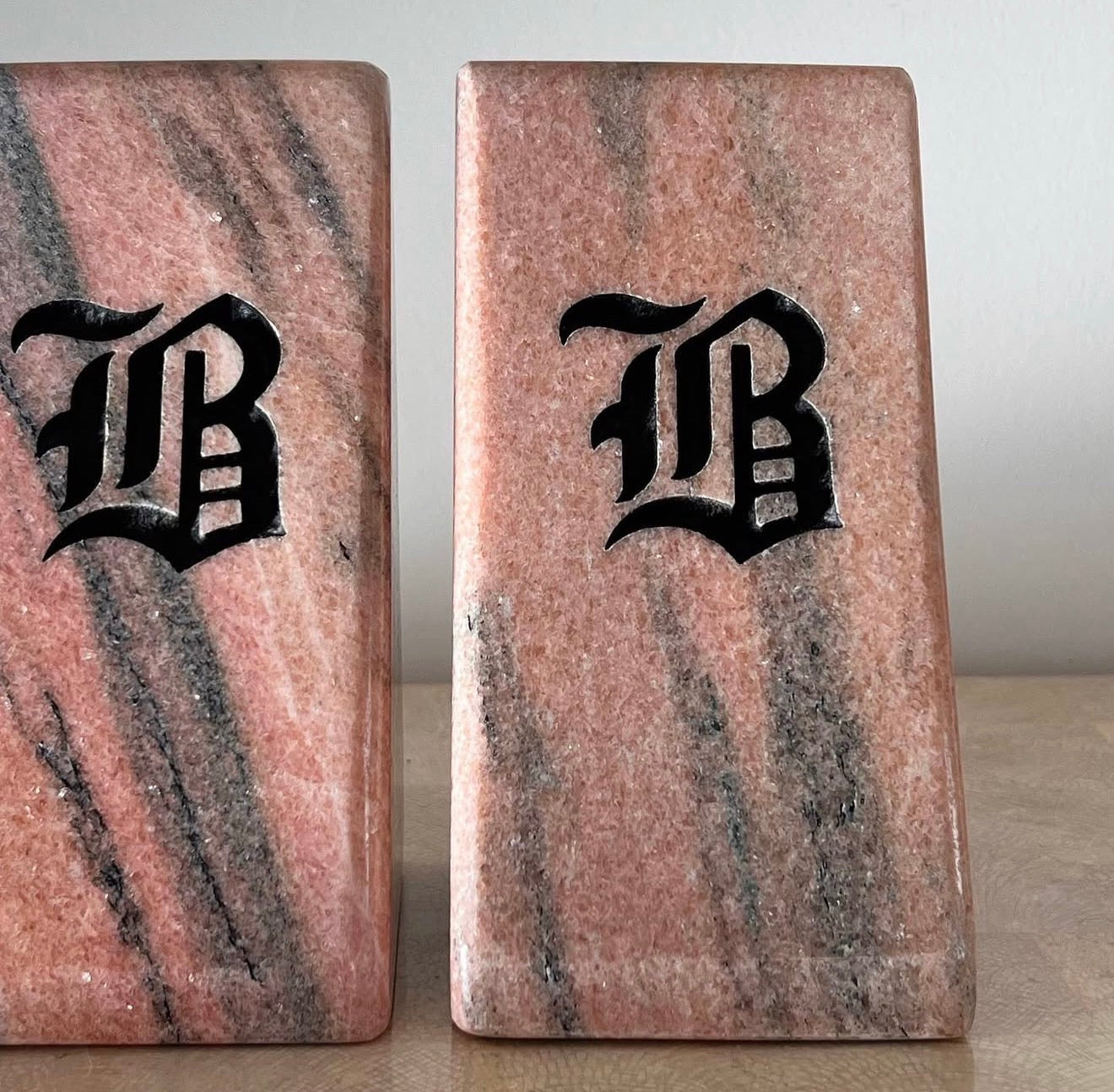 Postmodern pink marble “B” bookends, 20th century