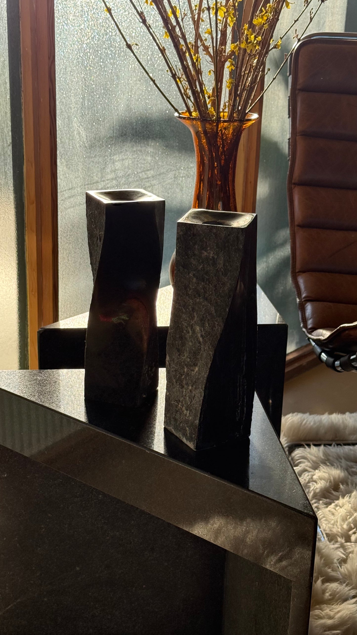 Pair of black stone candlesticks, late 20th century