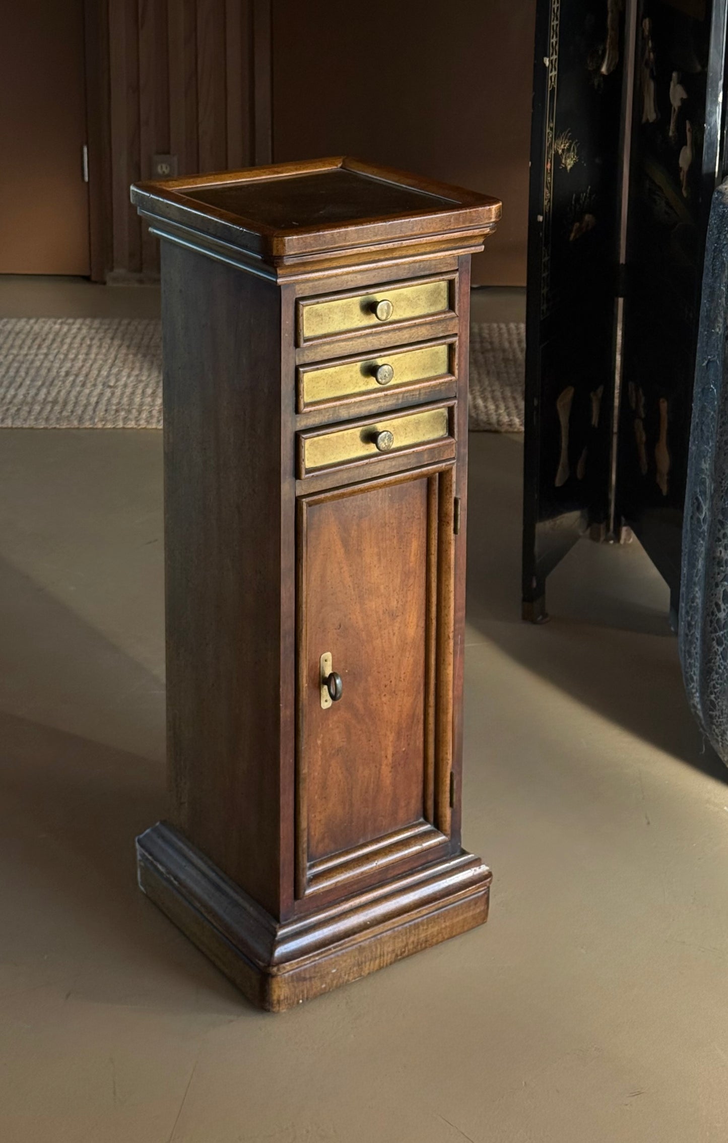 Wood and brass pedestal cabinet with pocket drawers, late 19th century