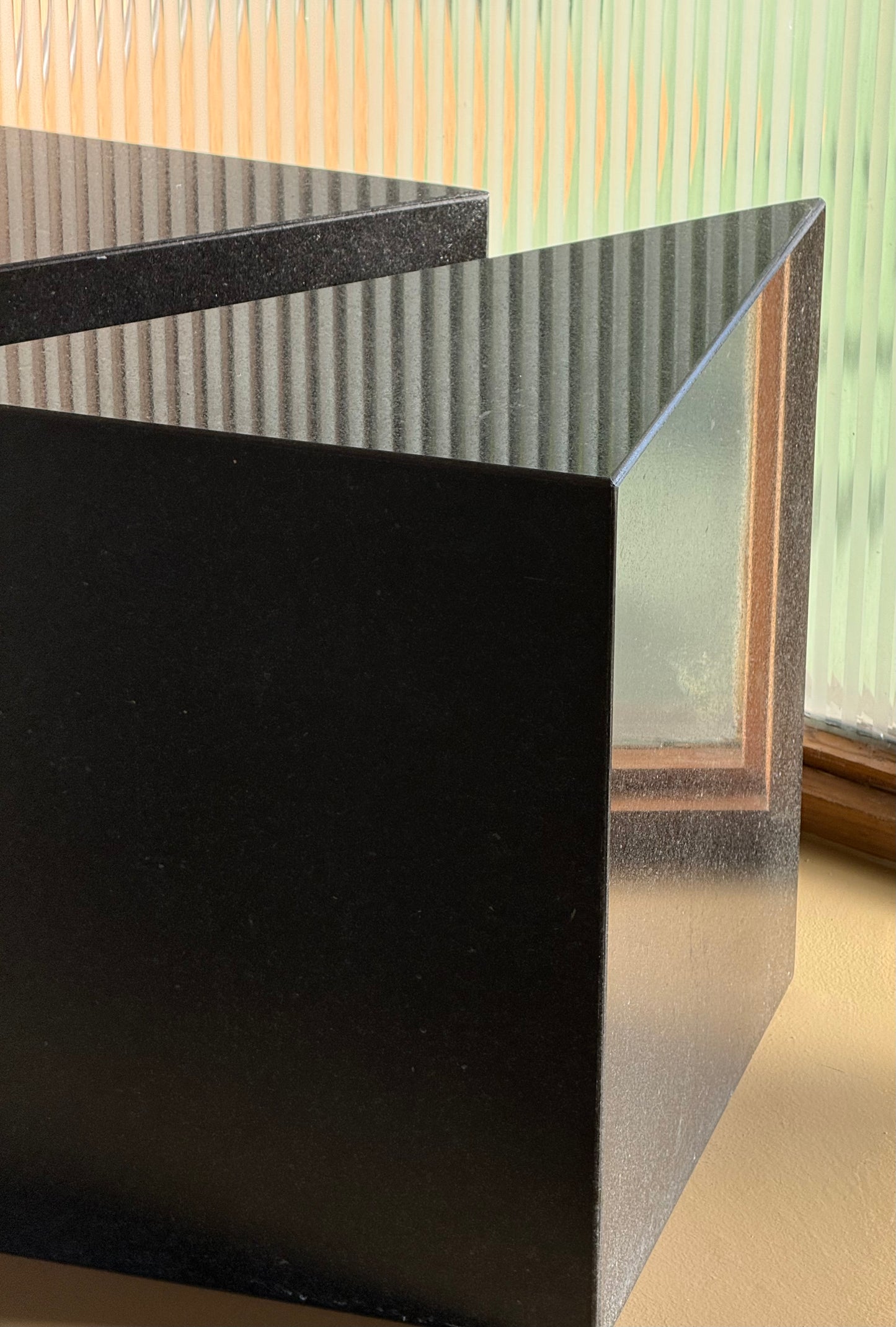 Pair of postmodern black granite triangular end tables, late 20th century