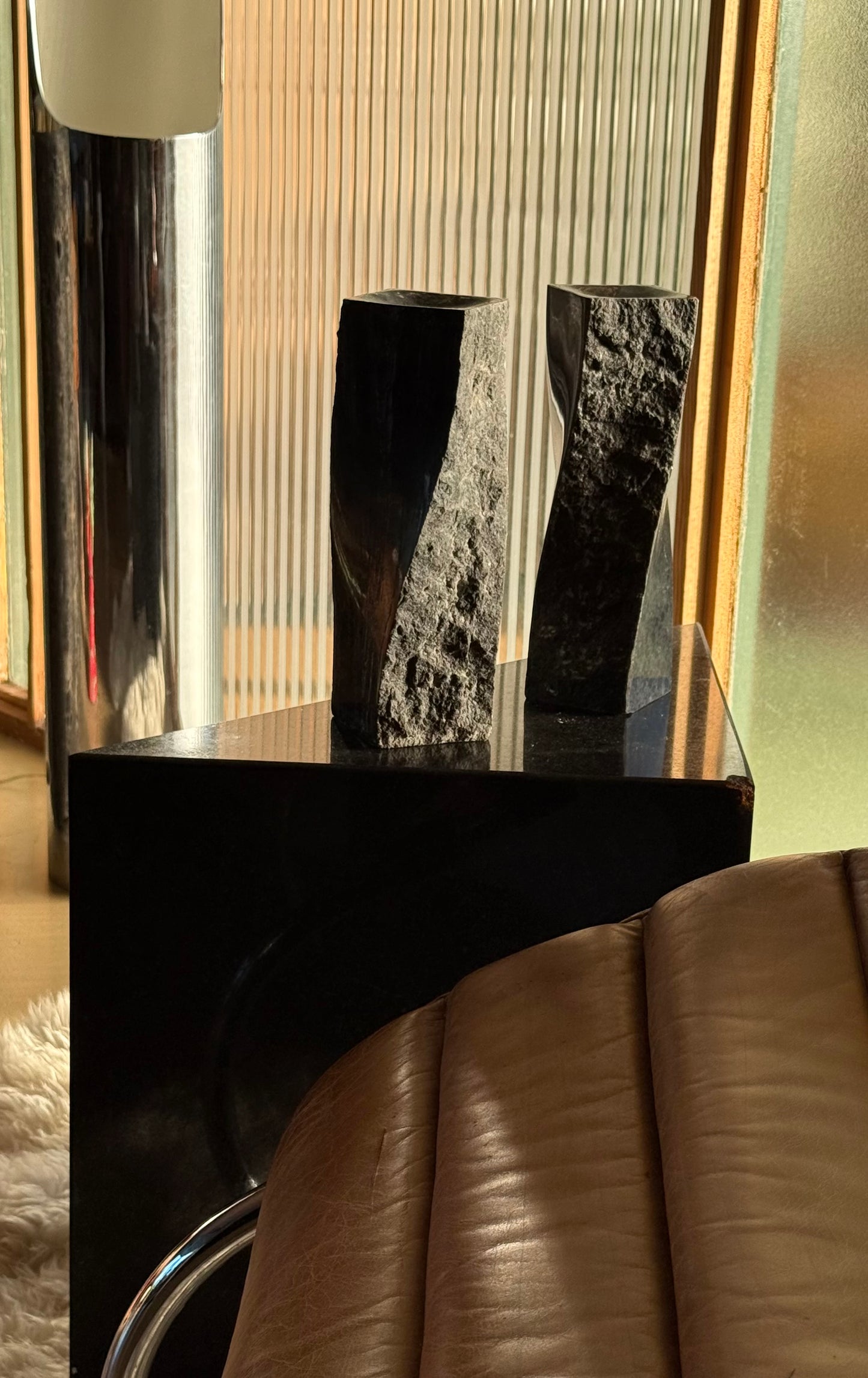 Pair of black stone candlesticks, late 20th century