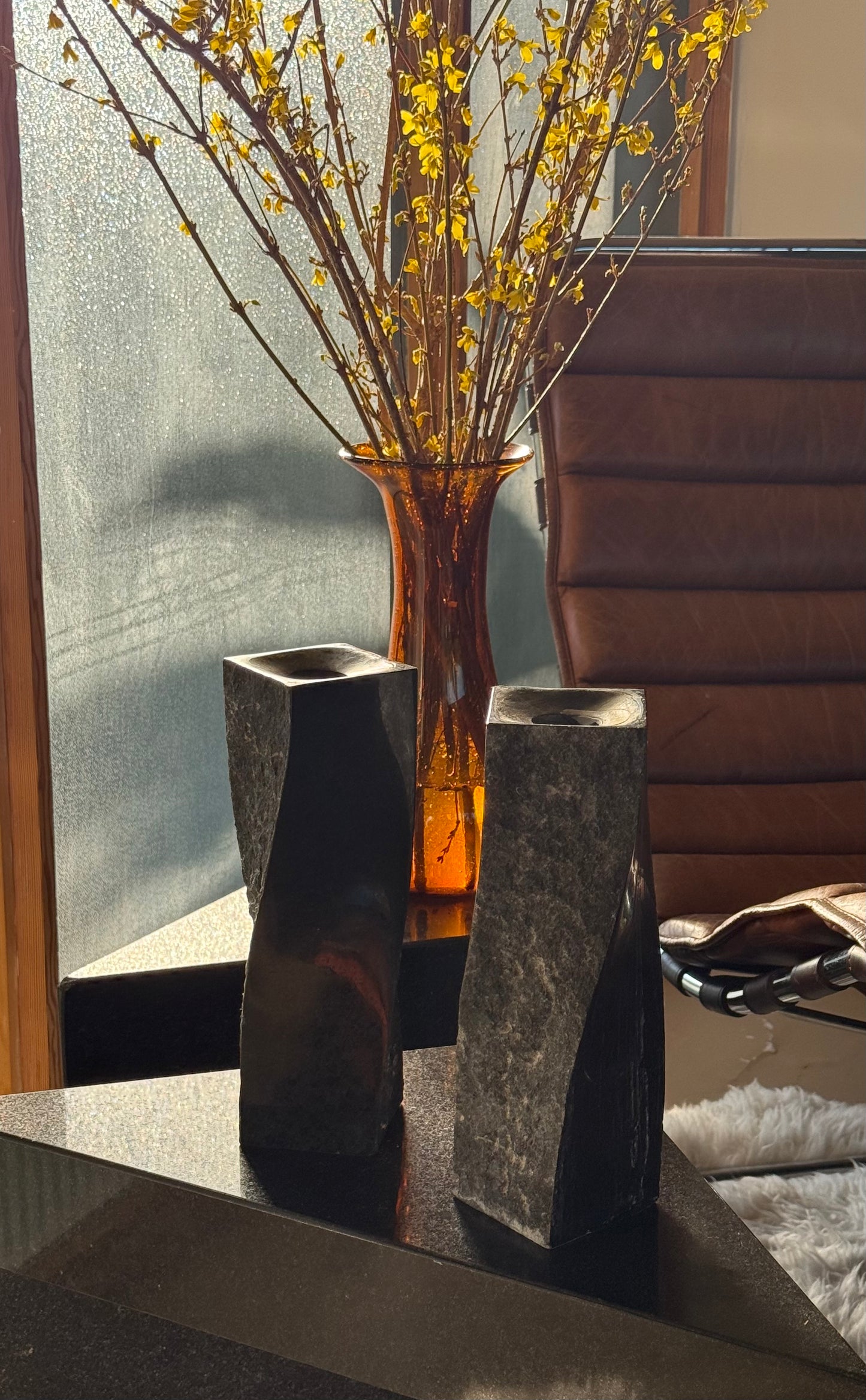 Pair of black stone candlesticks, late 20th century