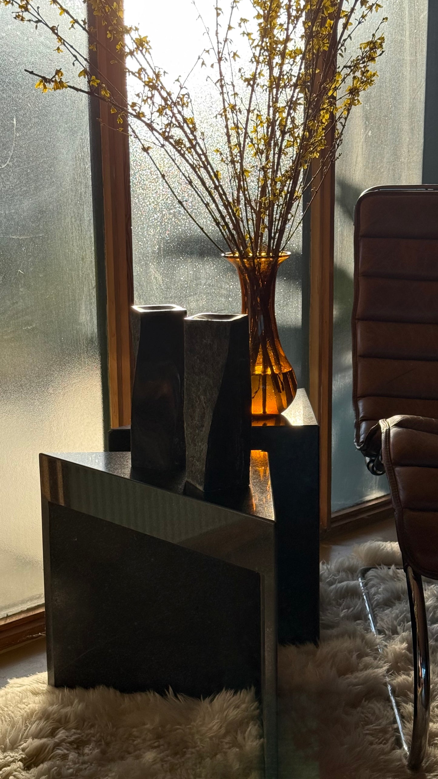 Pair of black stone candlesticks, late 20th century