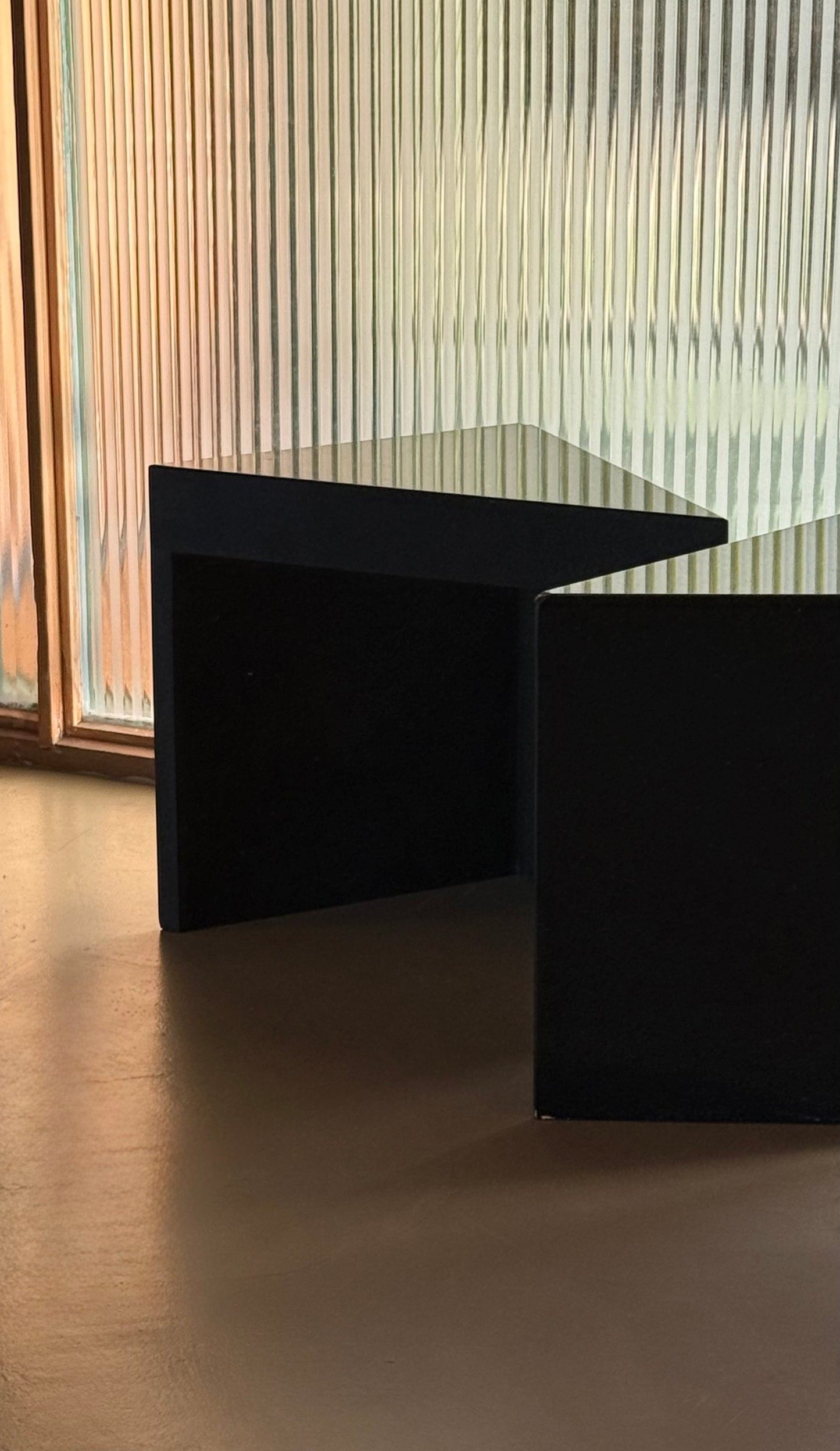 Pair of postmodern black granite triangular end tables, late 20th century