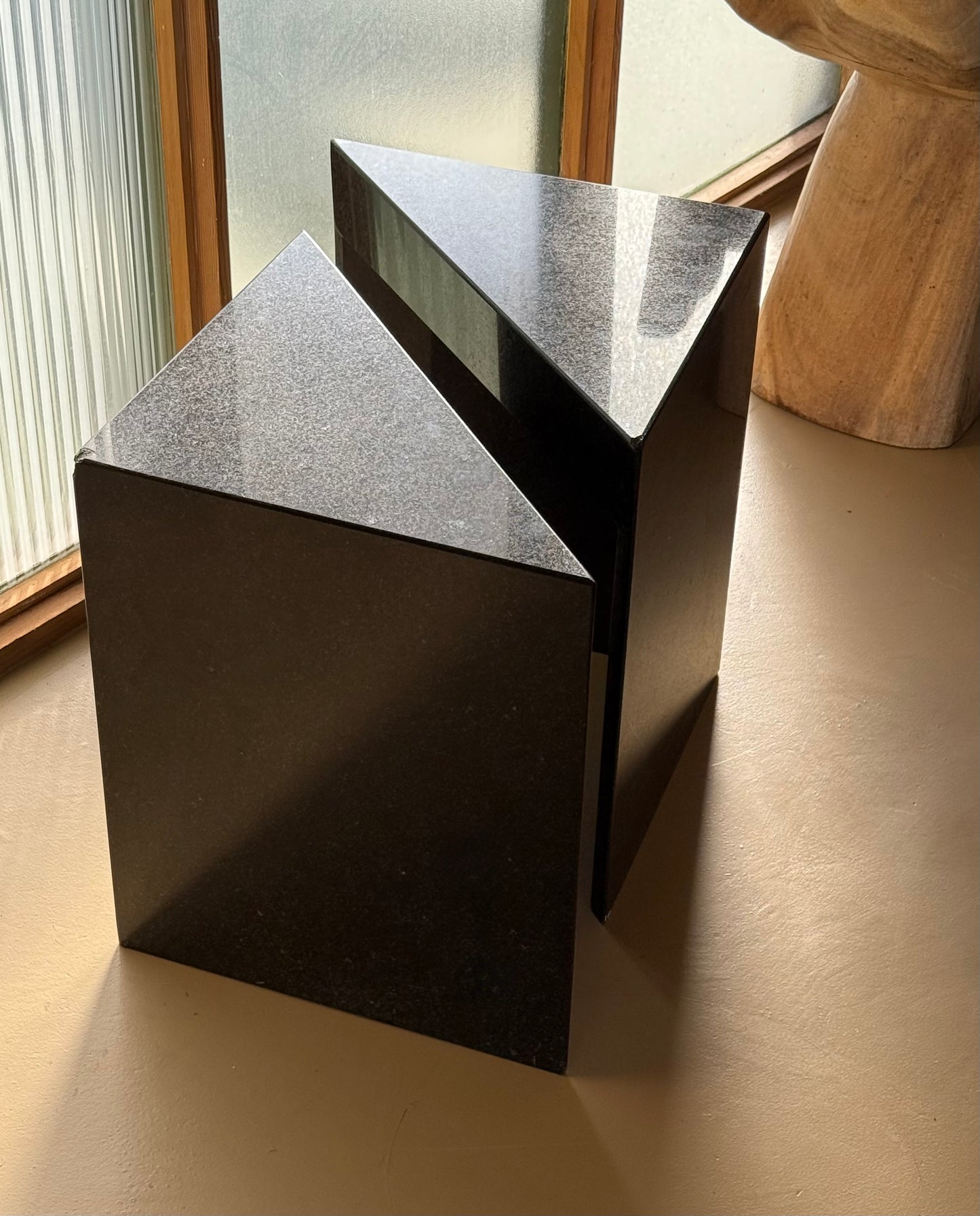 Pair of postmodern black granite triangular end tables, late 20th century